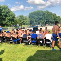 Football team eating at large table outdoors